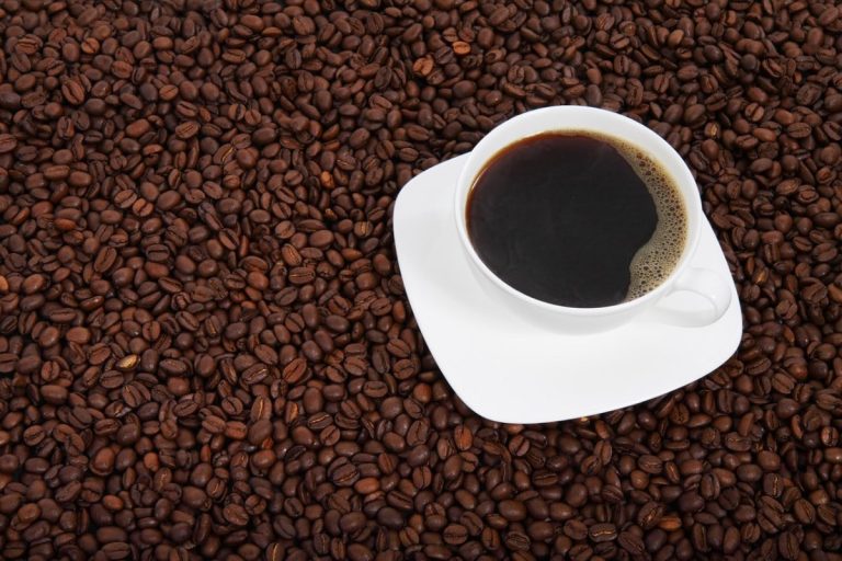 Cup of coffee with coffee beans