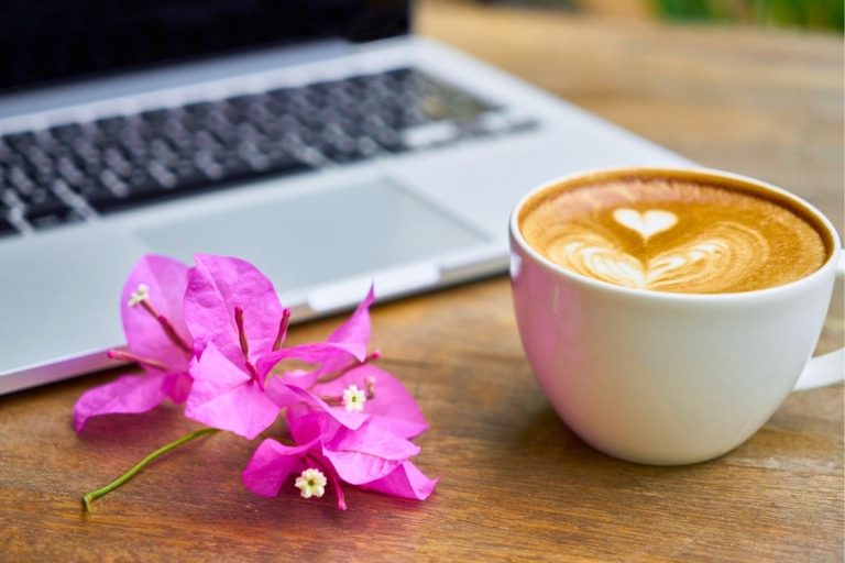 Laptop and coffee with pink flower