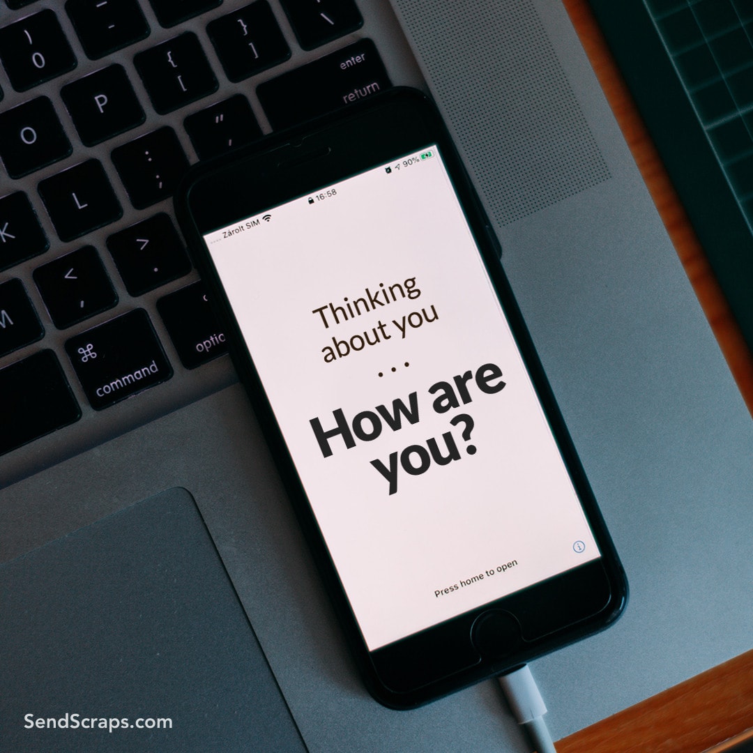 smartphone with a message on the screen: thinking about you... how are you?